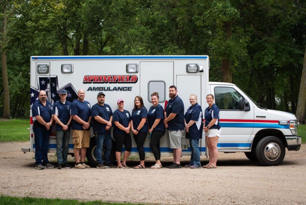 springfield mn ambulance team members in front of an ambulance