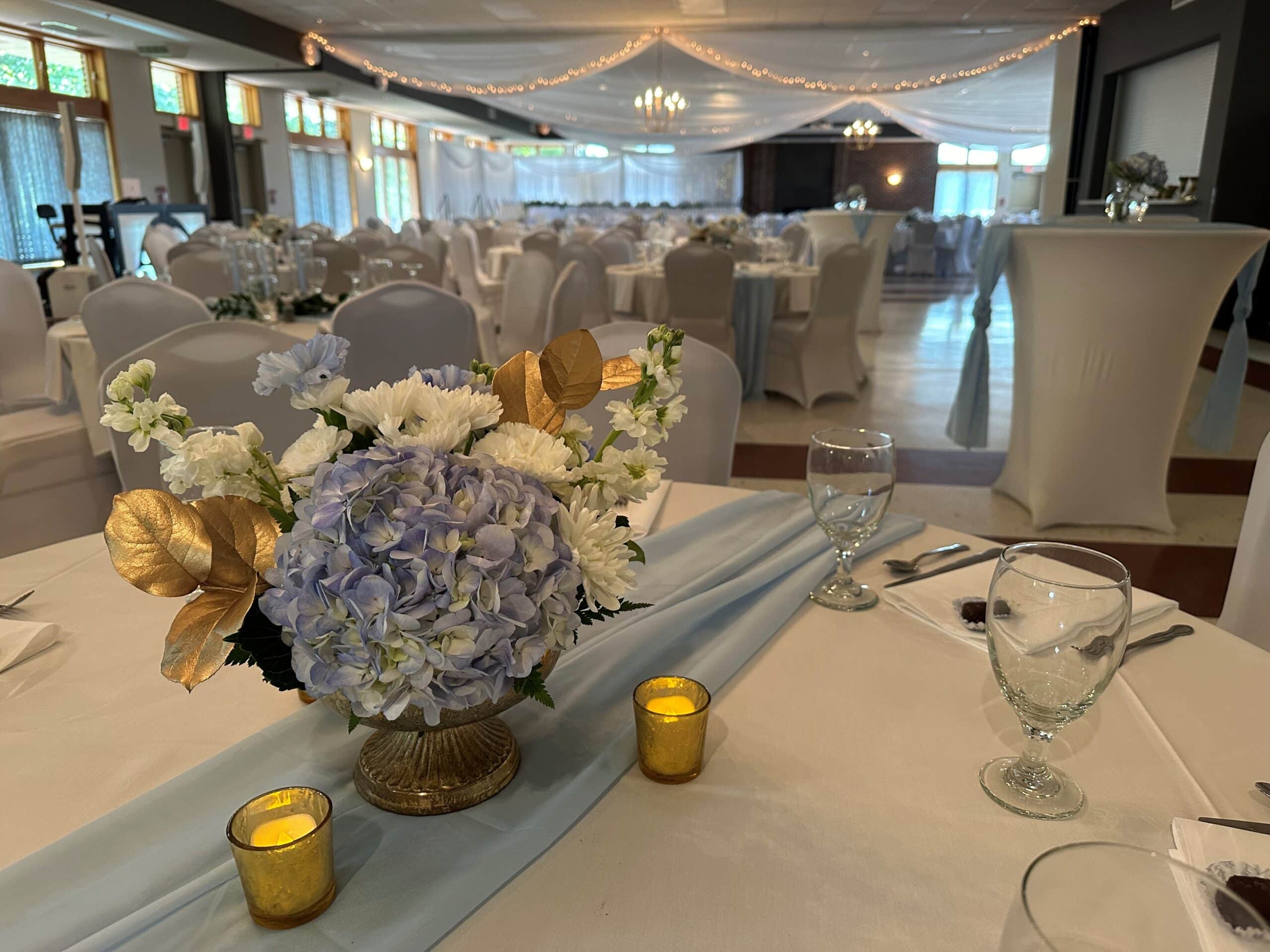 community center wedding reception decorative tables and chairs set up