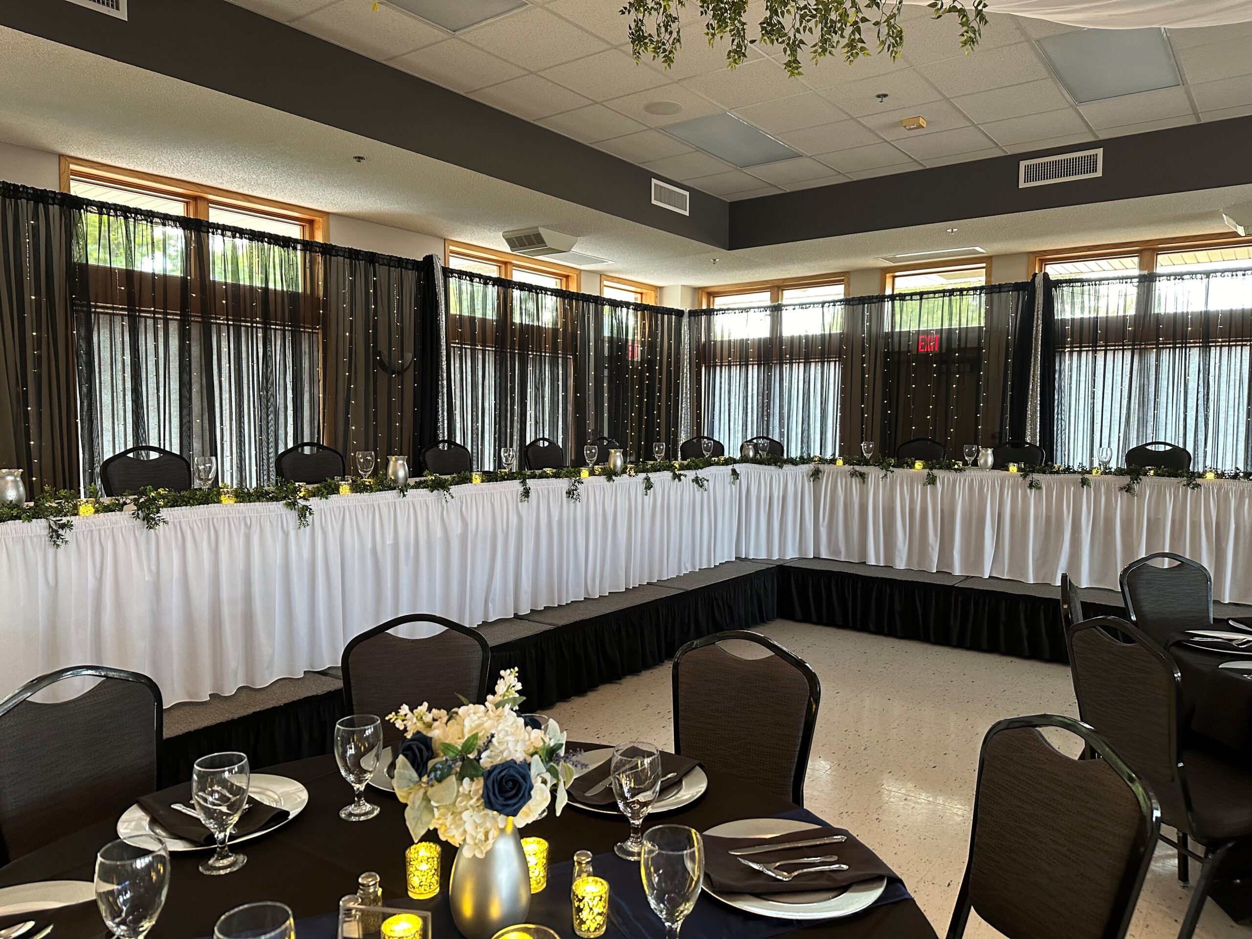 elegantly decorated head table setup at a wedding