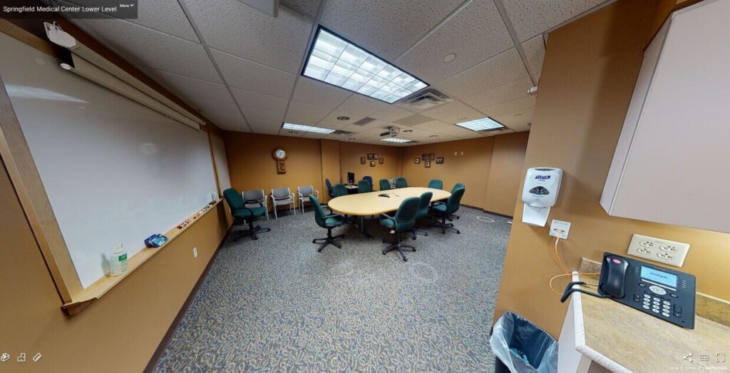 board room with table and chairs, white board